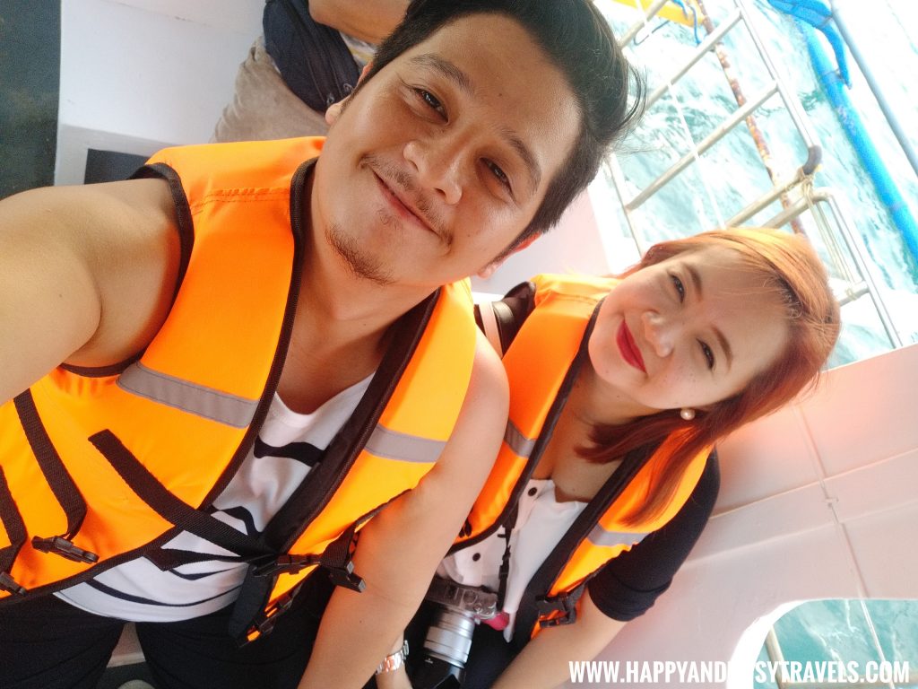 Happy and Busy wearing life jackets inside the boat